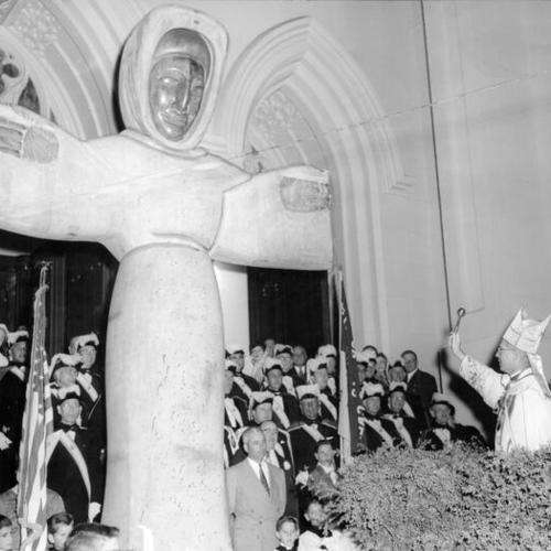 [Auxiliary Bishop Merlin J. Guilfoyle blessing the 16-foot statue of St. Francis of Assisi]
