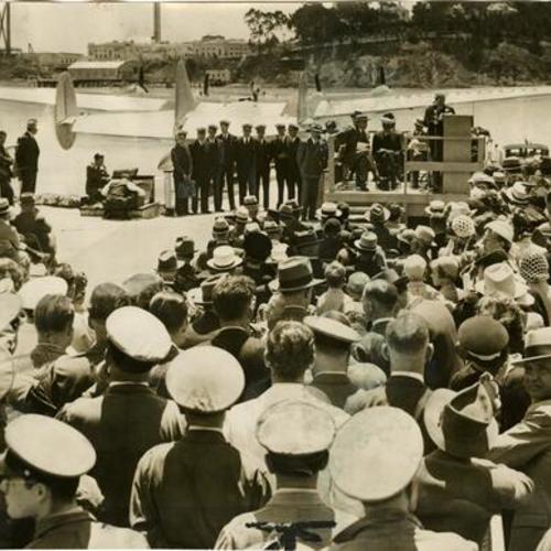 [Mayor Rossi gives speech to crowd at Treasure Island with the American Clipper in background]