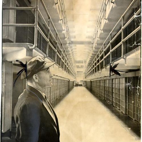 [Guard C. T. Perrin looking at empty cells after closing of prison on Alcatraz Island]