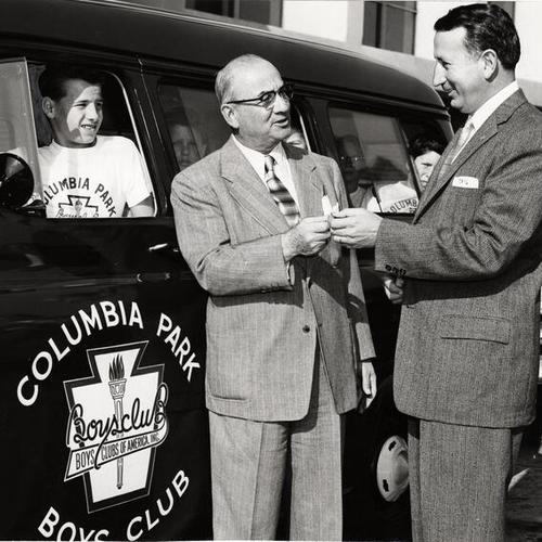 [Sales manager Frank Trains presents the keys to a new Chevrolet to A.J. Shragge board president of the Columbia Park Boys Club]
