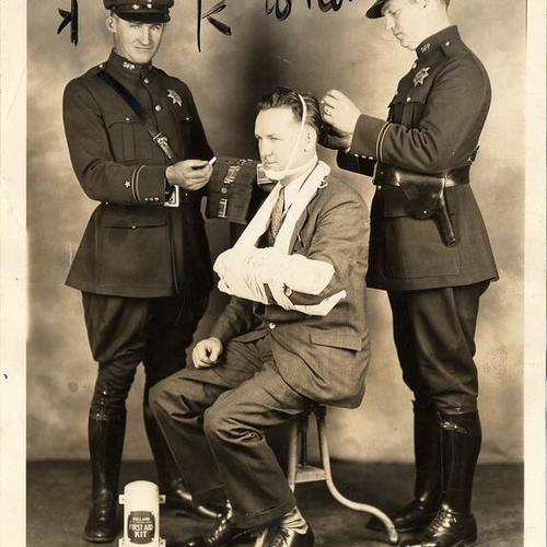 [(Officer Walter Martin, Sergeant Thomas McInerney, being assisted with first aid as a demonstration and Officer William Coultis]
