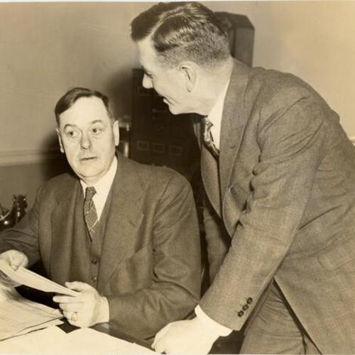 [Captain Bernard J. McDonald at his desk and Chief Charles Dullea (standing)]