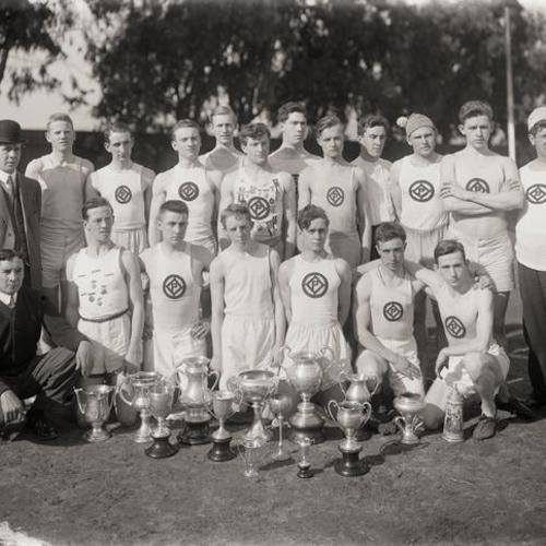 Y. M. C. A. relay racing team portrait with trophies on field