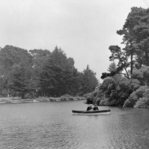 [Two people in a rowboat on Stow Lake in Golden Gate Park]