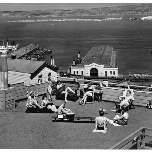 [Group of people sunbathing on a Telegraph Hill rooftop]