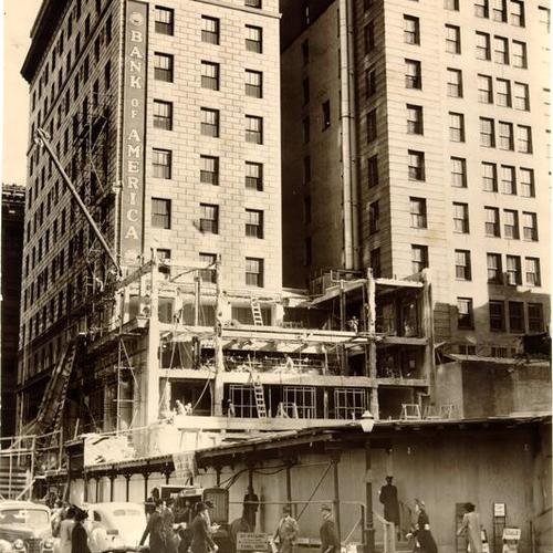[Wrecking company tearing down a building at Montgomery and Pine streets in preparation for construction of a new Bank of America branch building]