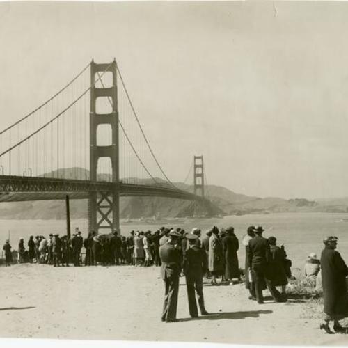 [Crowd of people watching military ships enter San Francisco Bay during the Golden Gate Bridge Fiesta]