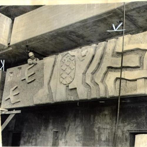 [Workmen working on sculptured panels that adorn the Ping Yuen North public housing development]