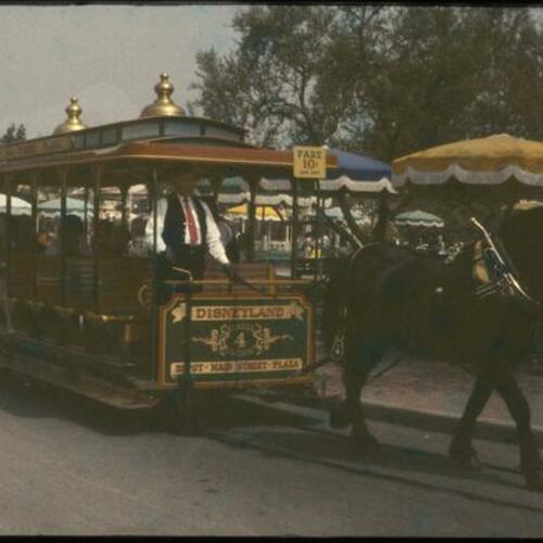 People on Disneyland Park horse-drawn streetcar
