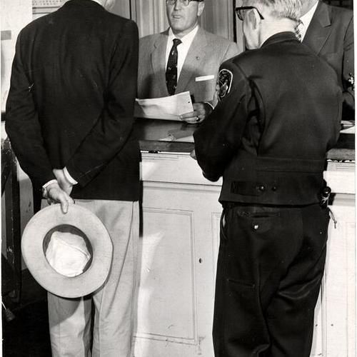 [Judge Carl Allen holding 'court' at the booking desk in Old Hall of Justice]