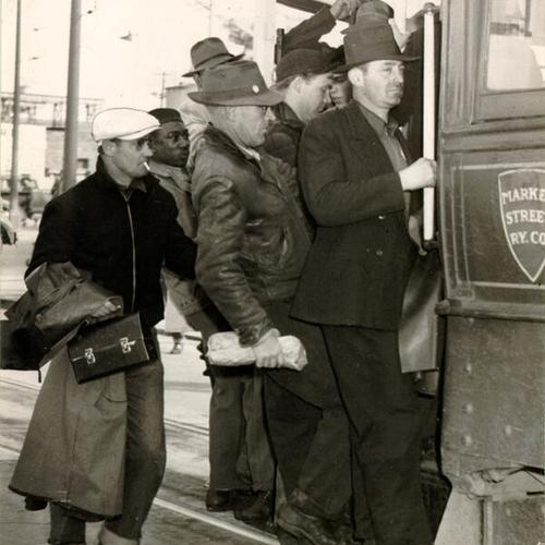 [Man trying to board a crowded No. 22 line streetcar]