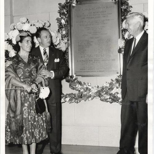 [Soprano Licia Albanese, General Director Kurt Herbert Adler and Edward L. Goeppner posing with a plaque in commemoration of the 25th anniversary of the War Memorial Opera House]