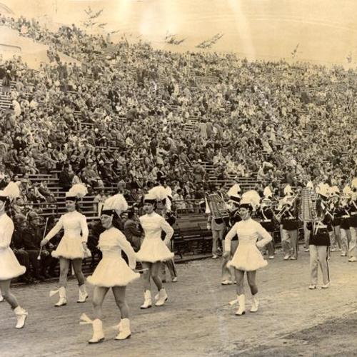 [Marching band playing for  crowd during an East-West Shrine football game at Kezar Stadium]