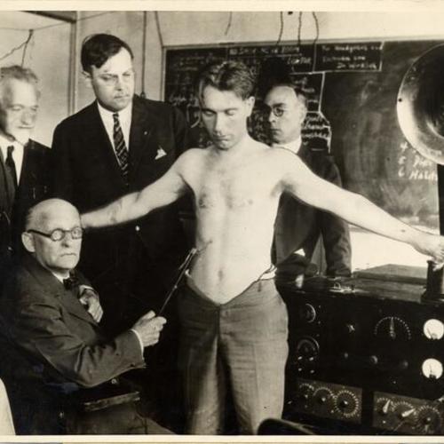 [Dr. Albert Abrams using his oscilloclast on a patient trying to locate cancer]