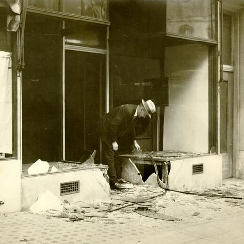 [C. R. Lawson inspecting a damaged store front at 614 Clay Street]