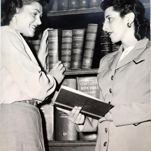 [San Francisco Public Library employees Mary Prevezich and Sophie Milinovich working in the reference department at the Main Library]