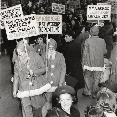 [Workers dressed in Santa Claus costumes picketing outside Kress store on Market Street]