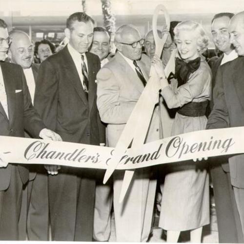 [Actress Marilyn Maxwell cutting the ribbon at the opening of Chandler's Shoe Store in Stonestown Shopping Center]