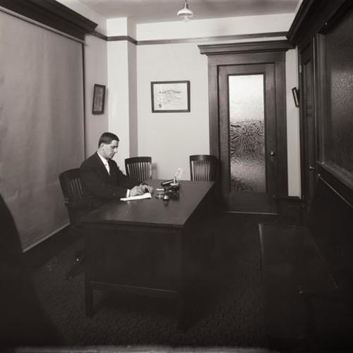 Person sitting in Y.M.C.A. office