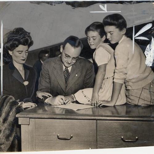 [District Attorney Edmund G. Brown, his wife Bernice and daughters Barbara and Cynthia.]