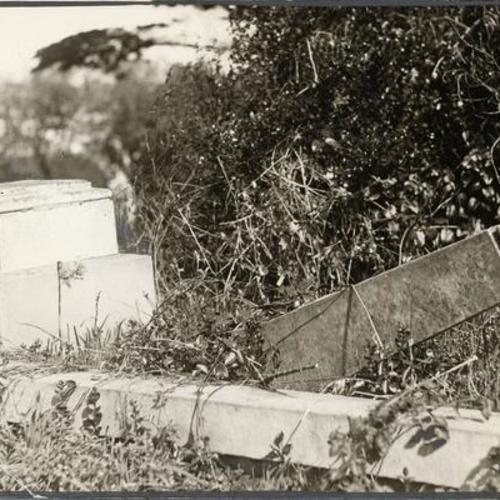 [Overturned gravestones at Laurel Hill Cemetery]