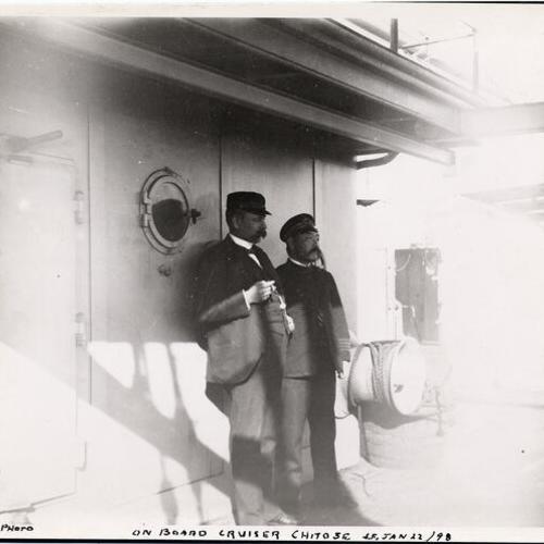 [Two men standing on the deck of the cruiser Chitose]