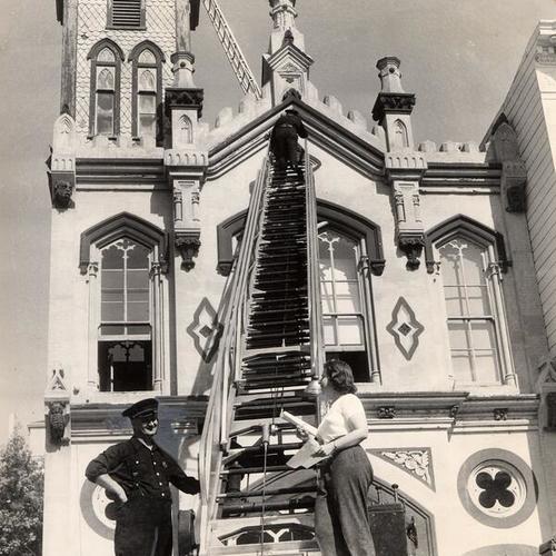 [Fireman Hines and architect Fifi Branner taking measurements at Fire Engine 15]