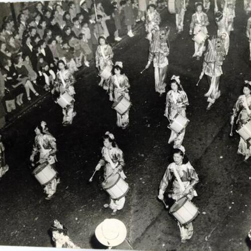 [Women marching in the Triple Seven celebration]