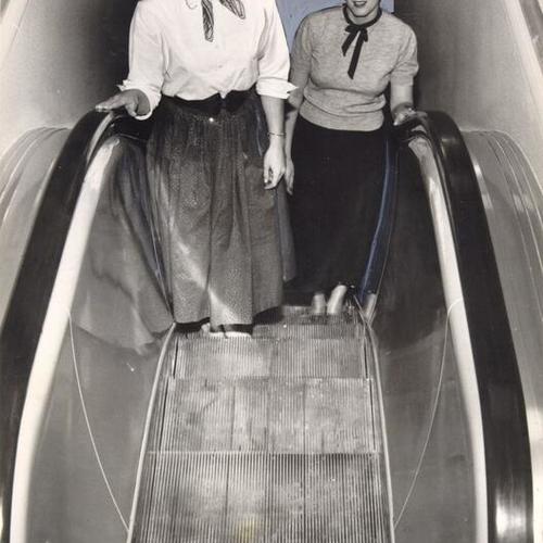 [Mrs. Doris Bullock and Mrs. Kay Nordstrom testing an escalator at a new J. C. Penney store in Westlake]