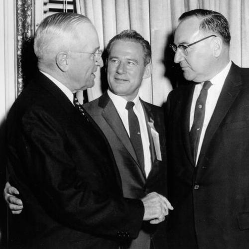 [Edmund G. (Pat) Brown (right) shakes hands with former President Harry S.Truman with Claire Engle in the middle]