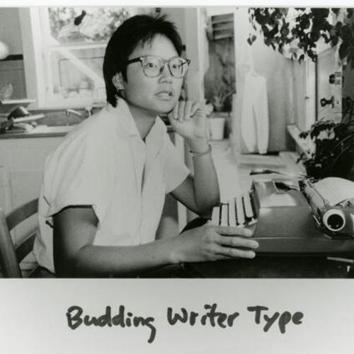 [A woman sitting at her typewriter]