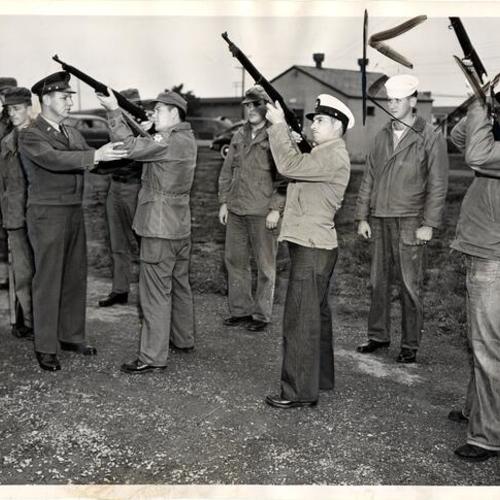 [Captain S. L. Piersall instructing students of joint Army-Navy Military Police School at the Presidio of San Francisco in correct firing procedures for military funerals]