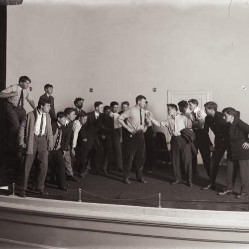 Actors on stage at Y. M. C. A. auditorium