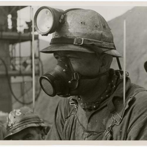 [Golden Gate Bridge riveter in helmet and gas mask]