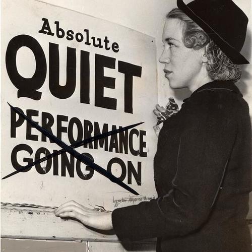 [Ruth Anderson reading the sign backstage at the Alcazar Theater that reads "absolute quiet, performance going on"]
