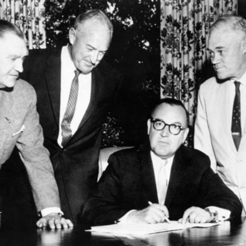 [Governor Edmund G. Brown, seated, signs into law a bill allocating $750,000 annually in gas tax money for small craft harbor development]
