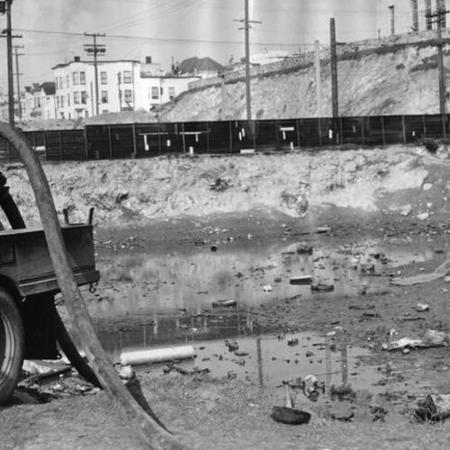 [Gasoline pump draining water from a lot on Market street and Duboce avenue]