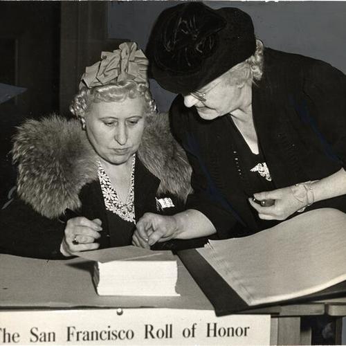 [Mrs. Bessie Lepper writing the first name in the Roll of Honor book of San Francisco World War II service men and women]