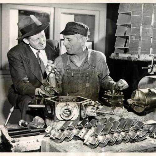 [Foreman Elmer Kenney and machinist Joe Barbetti at the Municipal Railway's Geneva shop]