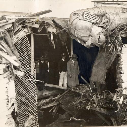 [View of hole on the ferryboat "Calistoga," unidentified men examine wreckage]