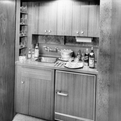 [Walnut paneled concealed bar and refrigerator in entrance foyer of Royal Suite at the Mark Hopkins Hotel]