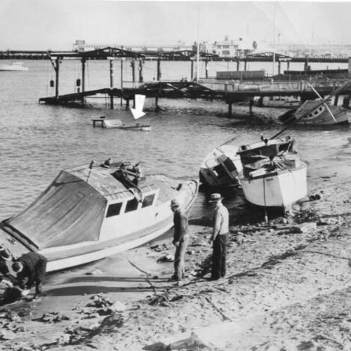 [Damaged boats along the shore after a storm]