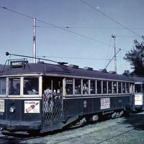 [Presidio Loop looking at Muni "D" line car 210 in blue and yellow paint scheme]