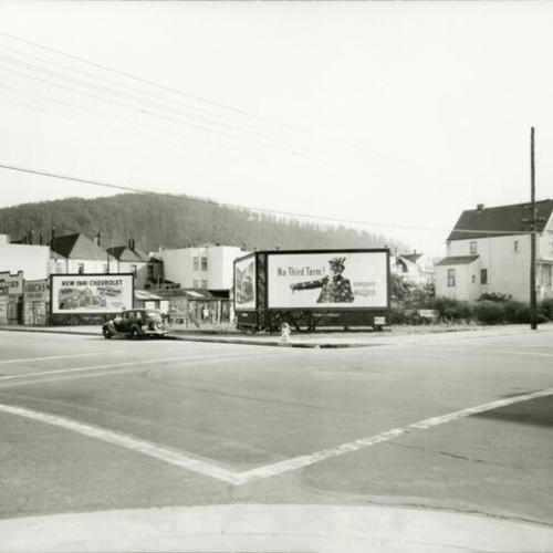 [Businesses, car and billboards on Irving and Funston Streets in 1941]