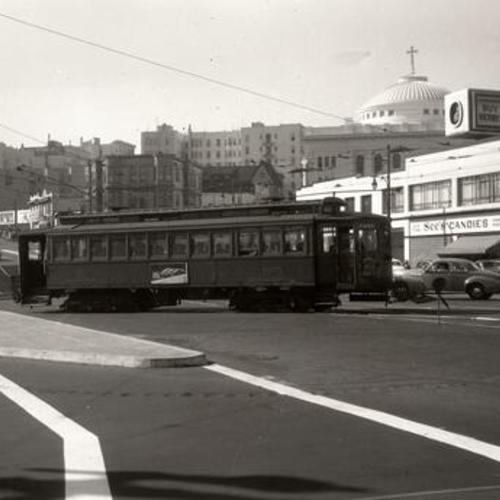 [Valencia and Market streets looking west at San Mateo Suburban #40 line car 1235 entering Market Street over temporary routing]