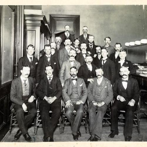 [Group of men posing in the Assessor's Office at City Hall]