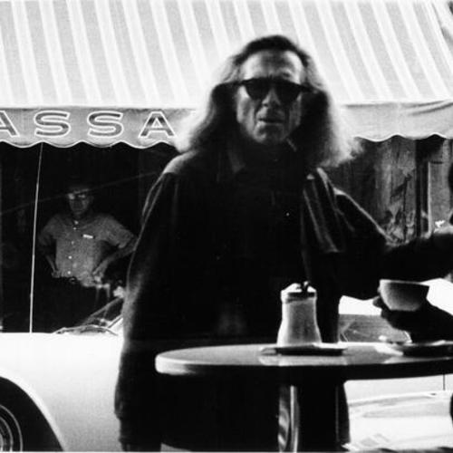 [Man standing in front of Malvina Coffee Shop in North Beach]