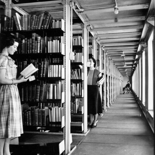 [Librarian Clare Pope retrieving a book from the stacks at the Main Library]