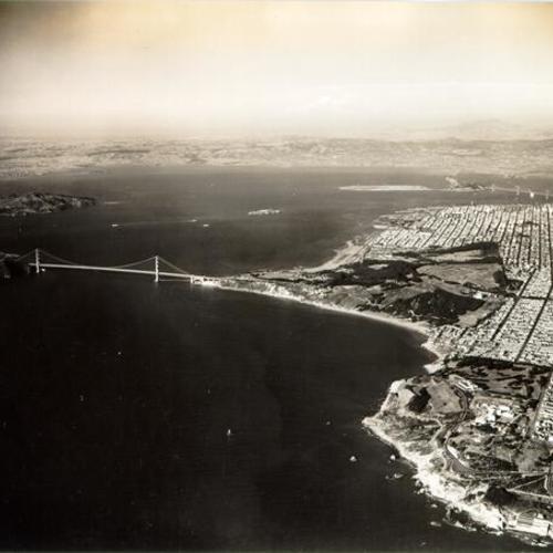 [Aerial view of the Golden Gate Bridge, San Francisco Bay and the northern end of San Francisco]