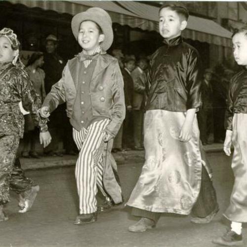 [Four Chinese youth marching in a parade for Madame Chiang Kai-Shek]